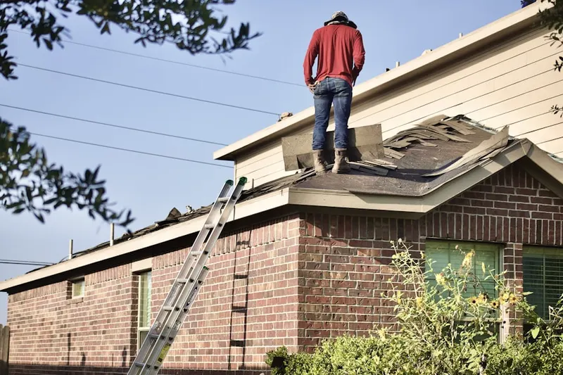 Professional roofer working on a residential roof in East Bay Drive